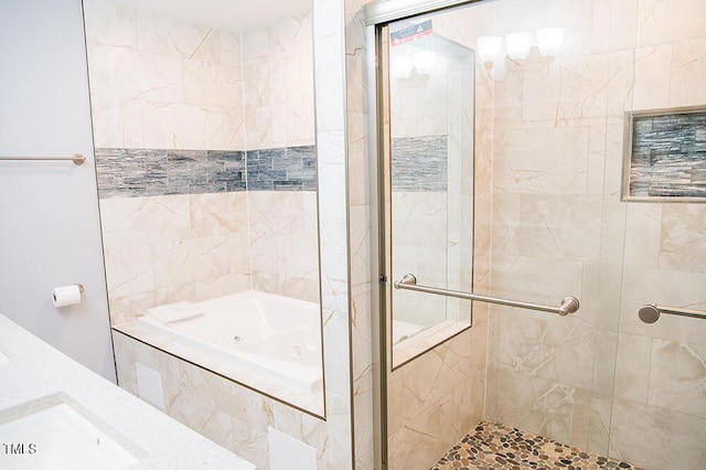 full bathroom featuring a whirlpool tub, a shower stall, and a sink