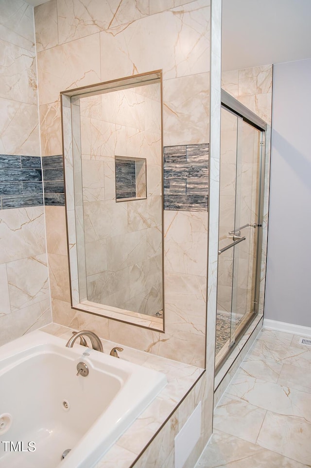 full bathroom with a stall shower, marble finish floor, and a jetted tub