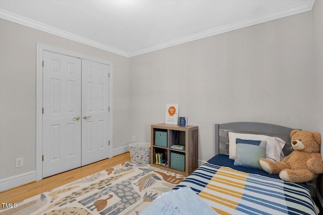 bedroom featuring ornamental molding, wood finished floors, and baseboards