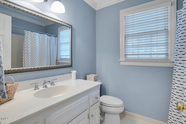 bathroom with toilet, ornamental molding, vanity, and a healthy amount of sunlight