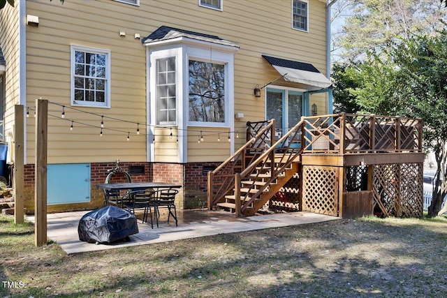 rear view of house with crawl space, a patio area, stairs, and a deck