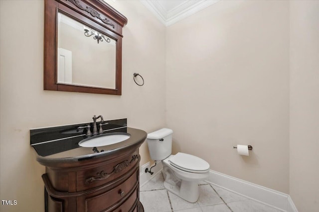 bathroom featuring toilet, baseboards, crown molding, and vanity