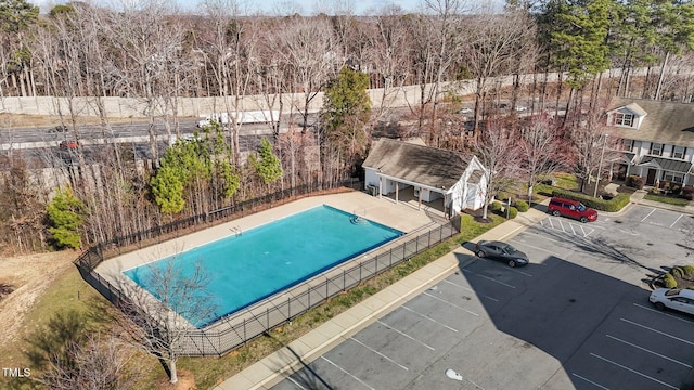 view of pool featuring fence and an outdoor structure