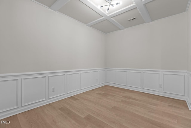 spare room with coffered ceiling, visible vents, and light wood-style flooring