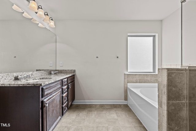 bathroom featuring double vanity, baseboards, a sink, and a bath