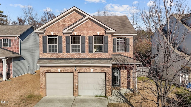 view of front of property featuring driveway, a shingled roof, and brick siding