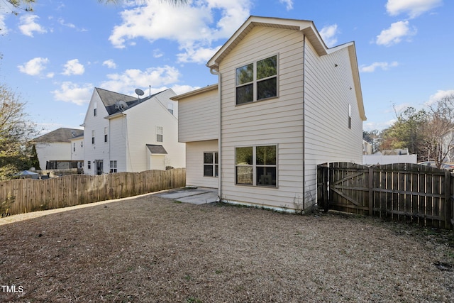 back of house with a patio and fence