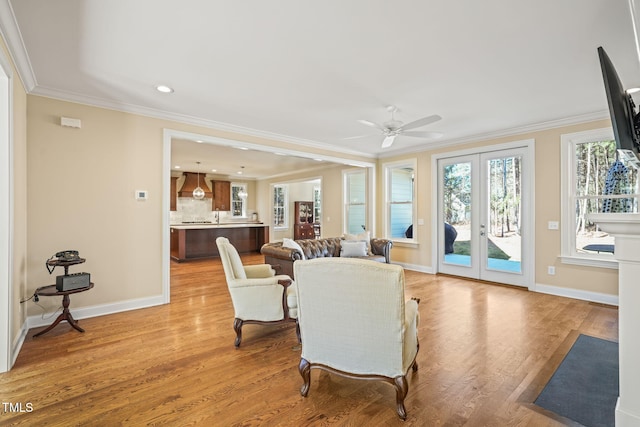 56 Mist Wood Ct, Pittsboro, NC 27312 - living room with crown molding, light wood-type flooring, a ceiling fan, french doors, and baseboards