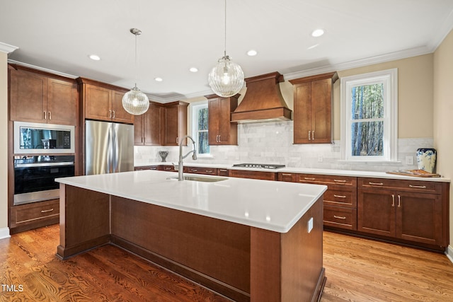 56 Mist Wood Ct, Pittsboro, NC 27312 - kitchen with custom range hood, light countertops, a center island with sink, stainless steel appliances, and a sink