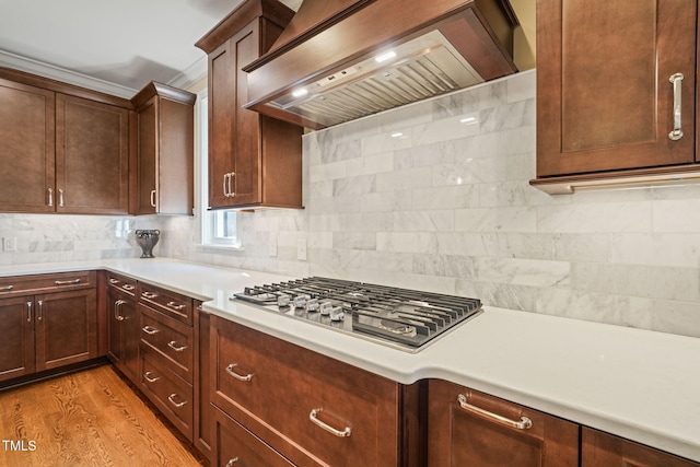 56 Mist Wood Ct, Pittsboro, NC 27312 - kitchen with custom range hood, stainless steel gas stovetop, light countertops, and decorative backsplash