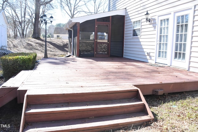 wooden deck featuring a sunroom