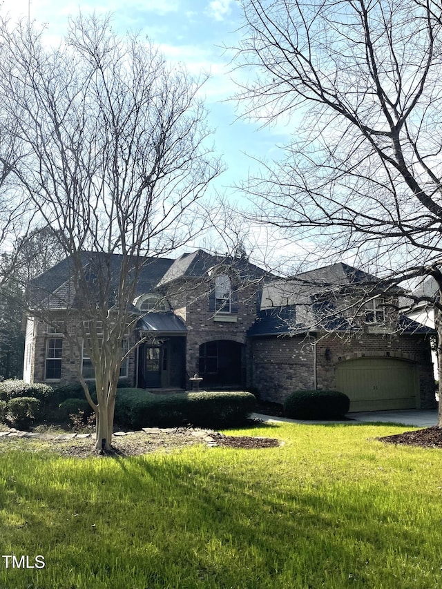 view of front of property featuring a garage and a front lawn