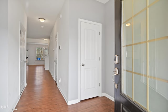 entryway featuring baseboards and dark wood finished floors