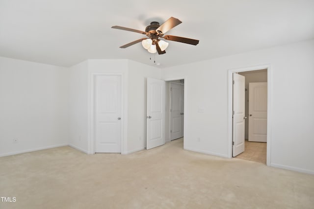 unfurnished bedroom featuring baseboards, a ceiling fan, and light colored carpet