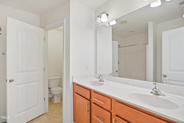 full bathroom featuring visible vents, double vanity, a sink, and toilet