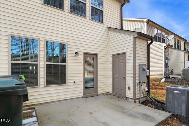 property entrance with a patio area and central AC unit