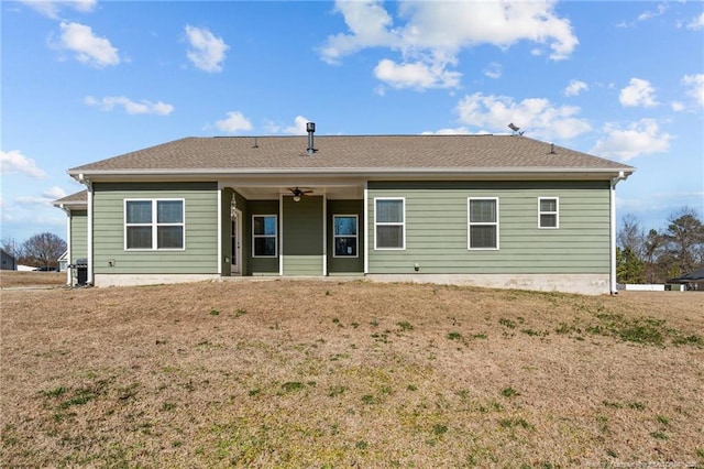 back of house featuring a ceiling fan and a yard