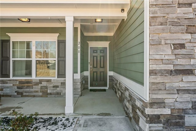 doorway to property featuring stone siding