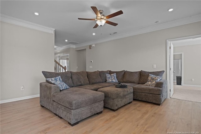 living area with light wood finished floors, baseboards, crown molding, and recessed lighting