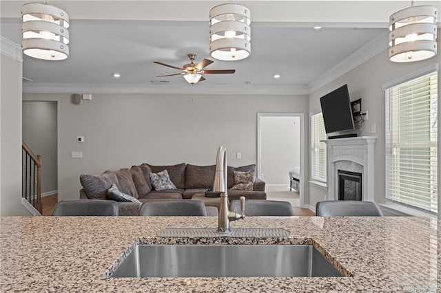 kitchen featuring pendant lighting, open floor plan, and a sink