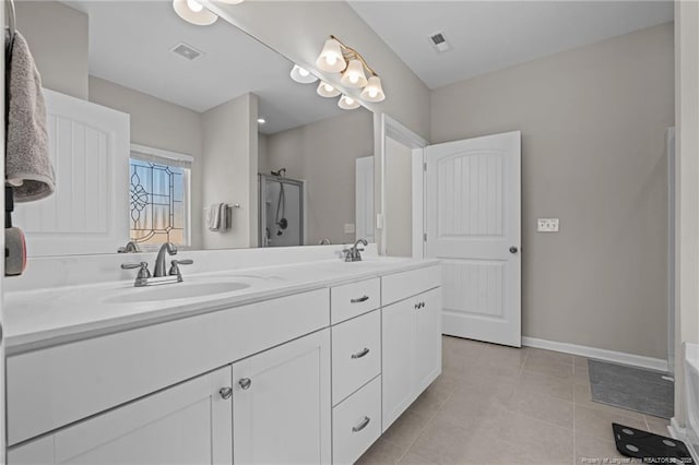 full bath with double vanity, visible vents, a stall shower, a sink, and tile patterned flooring