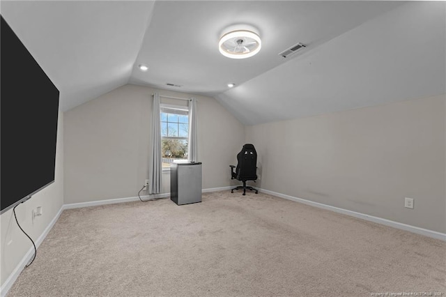 additional living space with lofted ceiling, light colored carpet, visible vents, and baseboards