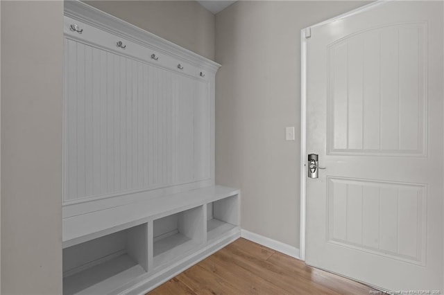 mudroom featuring baseboards and light wood finished floors