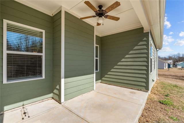 view of exterior entry featuring a patio area and ceiling fan