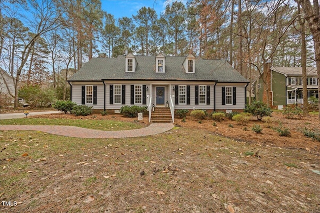 new england style home with crawl space and roof with shingles