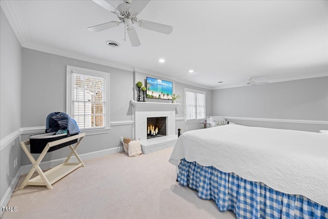 carpeted bedroom with a brick fireplace, visible vents, ornamental molding, and a ceiling fan