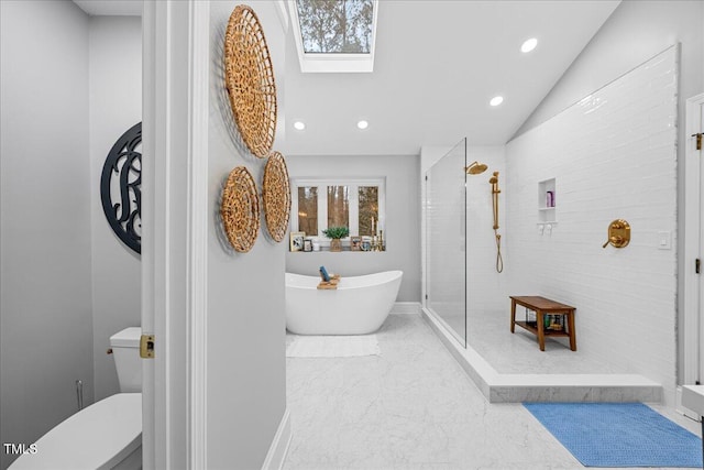 full bath featuring recessed lighting, a freestanding bath, toilet, lofted ceiling with skylight, and a shower stall