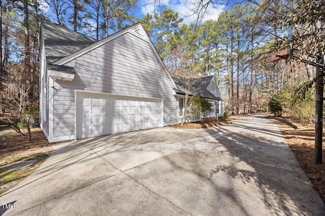 view of home's exterior featuring a garage and concrete driveway