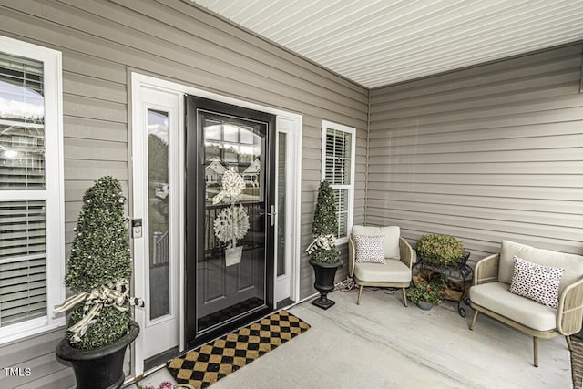 view of exterior entry featuring a porch