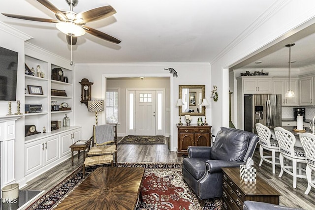 living room featuring ornamental molding, ceiling fan, and dark wood-style floors