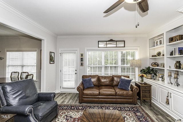 living area with dark wood-style flooring, ornamental molding, and ceiling fan