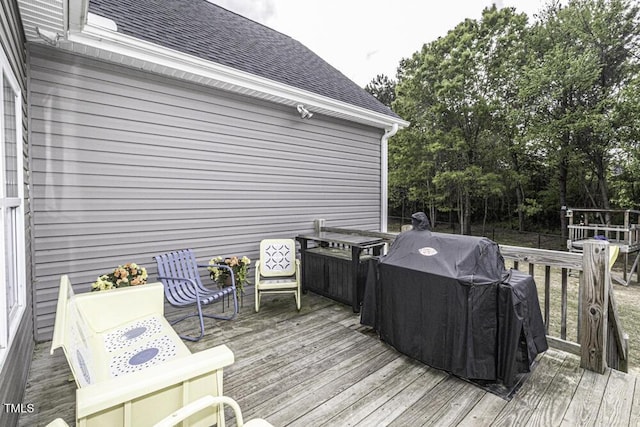 wooden terrace featuring area for grilling