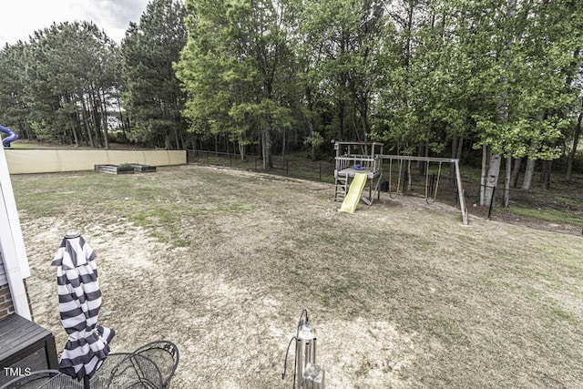 view of yard with fence and a playground