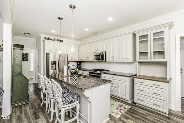 kitchen featuring dark wood-type flooring, ornamental molding, decorative backsplash, and stainless steel appliances