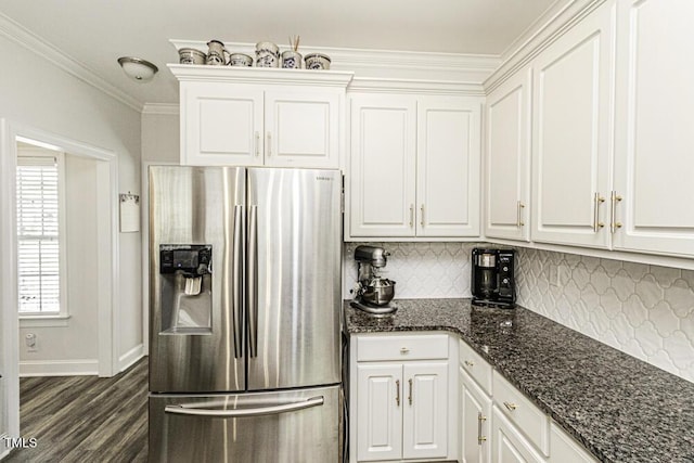 kitchen with stainless steel fridge with ice dispenser, dark wood finished floors, crown molding, white cabinetry, and decorative backsplash