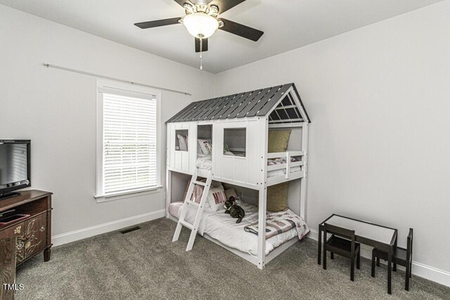 carpeted bedroom featuring baseboards and a ceiling fan