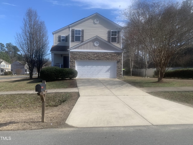 traditional-style house featuring a garage, stone siding, concrete driveway, and fence