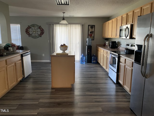 kitchen with a textured ceiling, dark wood-style flooring, stainless steel appliances, and a sink