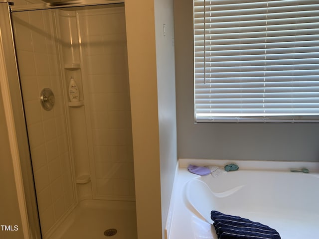 full bath with a stall shower and a bath