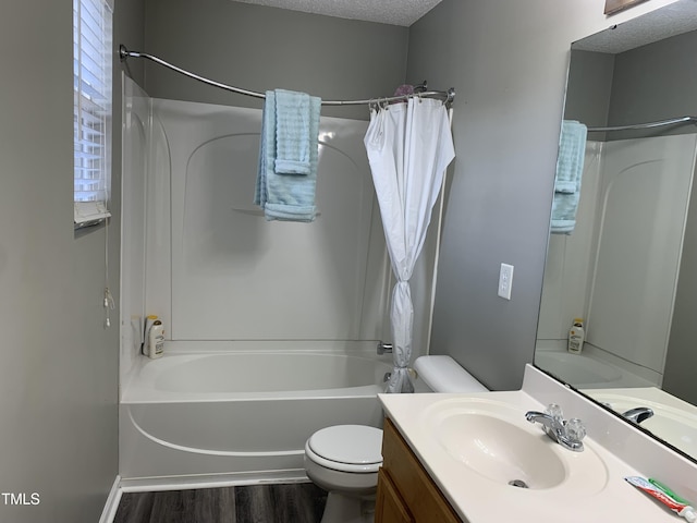 full bath featuring toilet, wood finished floors, shower / bathtub combination with curtain, a textured ceiling, and vanity