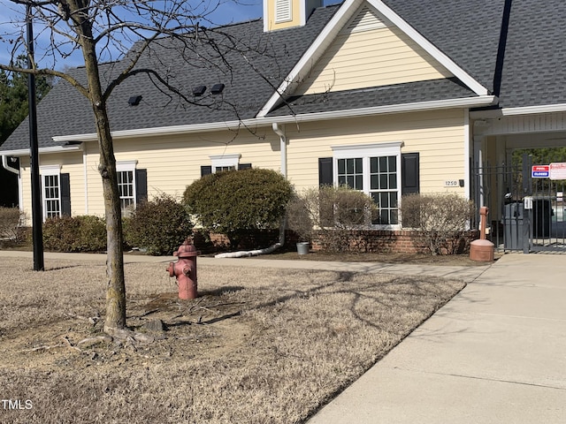 view of side of home featuring a shingled roof