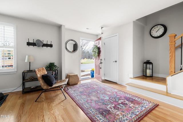 entryway featuring stairway, baseboards, and wood finished floors