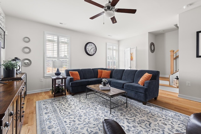 living room with light wood-style flooring, a healthy amount of sunlight, and visible vents