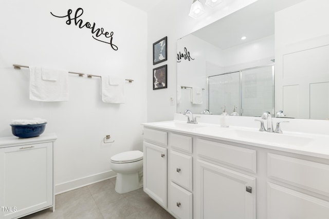 full bathroom with a sink, toilet, a stall shower, and double vanity