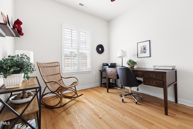 office area with baseboards, visible vents, and light wood-type flooring