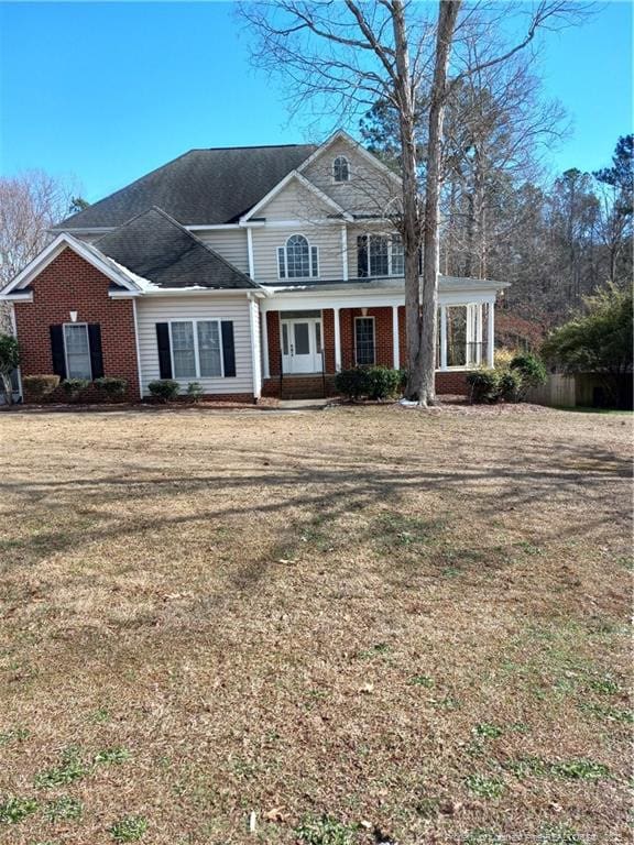 view of front facade with a front lawn and brick siding